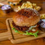 Salma's Burger with grilled beef patty, tomatoes, onions, pickles, and special sauce