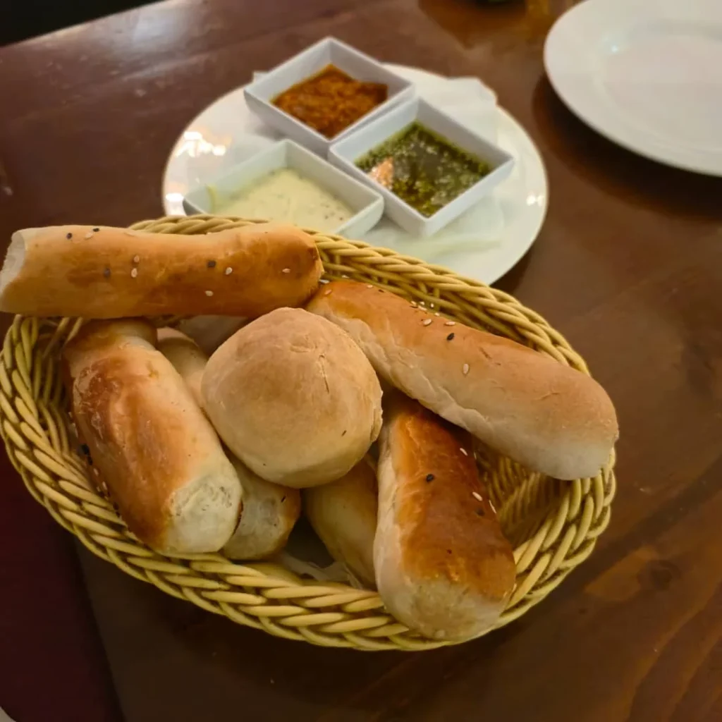 Fresh bread with zaatar seasoning on a wooden board